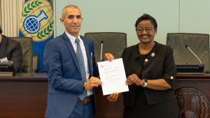 Mr Fareh Merdj, Deputy Director Physics Chemistry at NICC/GM, (left) receives an OPCW Designated Laboratory certificate on behalf of Algeria’s National Institute of Criminalistics and Criminology from Ambassador Odette Melono, OPCW Deputy Director-General (right)